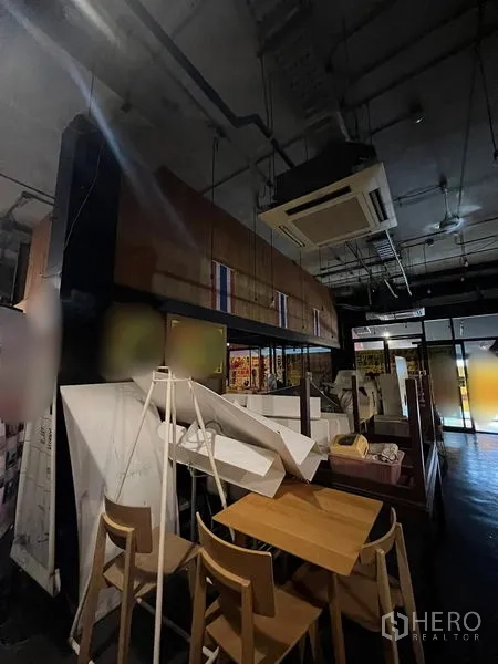 Retail Space for rent in Watthana, Bangkok - Dining area with high ceiling, cassette air-conditioning and wooden furniture.