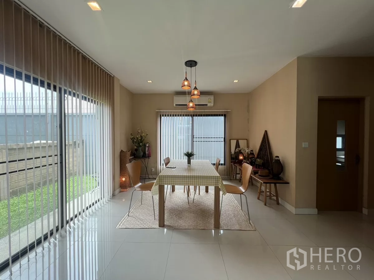 Detached House for rent in Bang Kapi, Bangkok - Sun-lit dining corner with three pendant lamps, AC, and full-height blinds.
