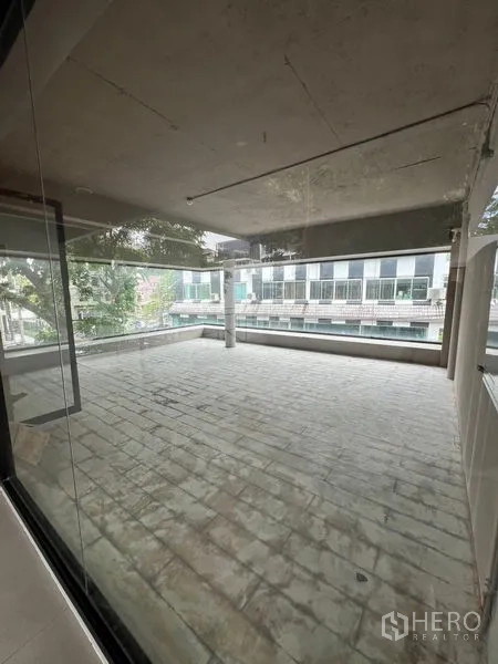 Retail Space for rent in Watthana, Bangkok - Wide view of corner space with glass on two sides and neighborhood outlook.