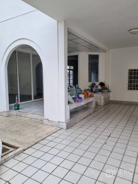 Detached House for rent or sale in Sathon, Bangkok - Covered outdoor area with arches, tiled floor and built-in bench.