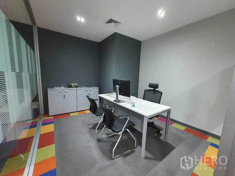 Office Space for rent in Ratchathewi, Bangkok - Private office with a desk, visitor chairs, and glass wall.
