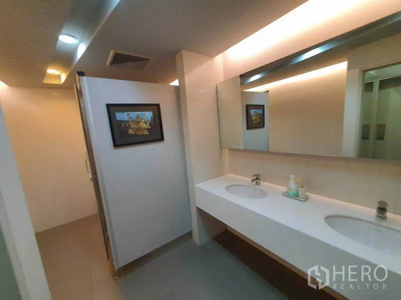 Office Space for rent in Ratchathewi, Bangkok - Modern restroom with double-sink vanity, large mirror, and warm lighting.