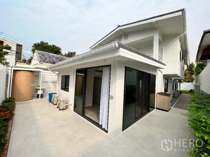 Detached House for rent in Phaya Thai, Bangkok - Rear patio with sliding glass doors, tiled terrace and water tank.