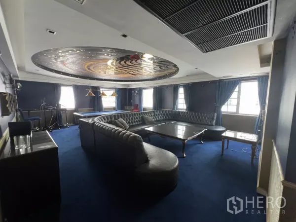 Retail Space for rent in Watthana, Bangkok - Blue-themed room with curved leather sectional, pool table and decorative ceiling lights.