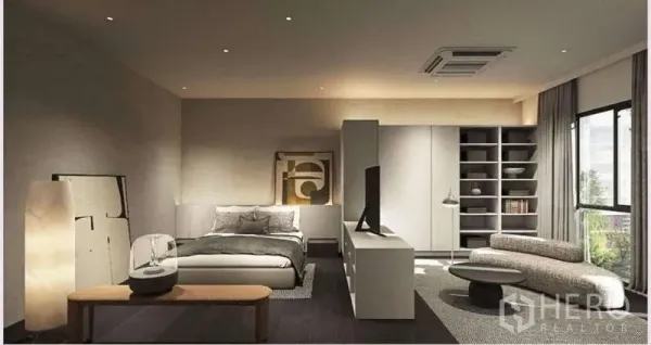 Townhouse for rent in Suan Luang, Bangkok - Spacious master bedroom with sitting area, built-in cabinetry, and a large window bringing in natural light.
