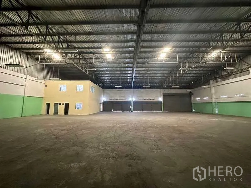 โรงงาน ให้เช่าในNonthaburi - มุมมองตรงไปยังประตูโหลดสินค้าและออฟฟิศสองชั้นภายในโกดัง.