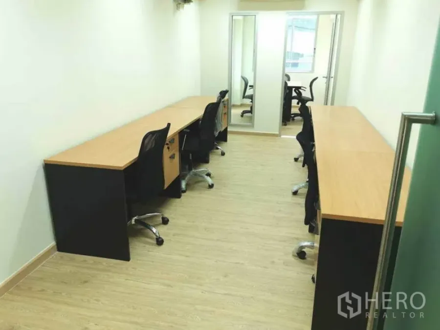 Office Space for rent in Khlong Toei, Bangkok - Open-plan 35 sqm office with long workstations, mesh chairs and glass door to meeting room.