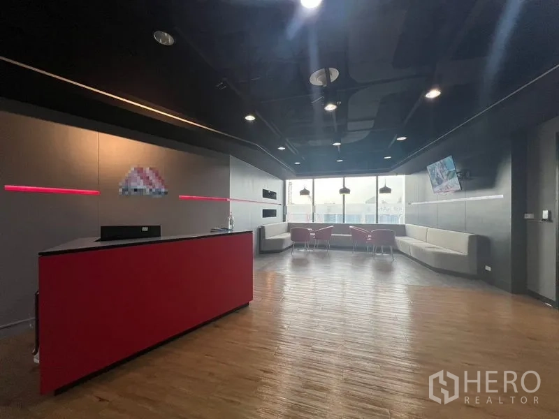 Office Space for rent in Huai Khwang, Bangkok - Modern reception with red counter, wood flooring and skyline outlook.