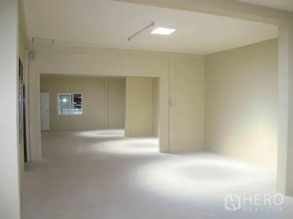 Warehouse for rent in Wang Thonglang, Bangkok - Bright partitioned office or workspace inside the warehouse with windows and overhead lighting.