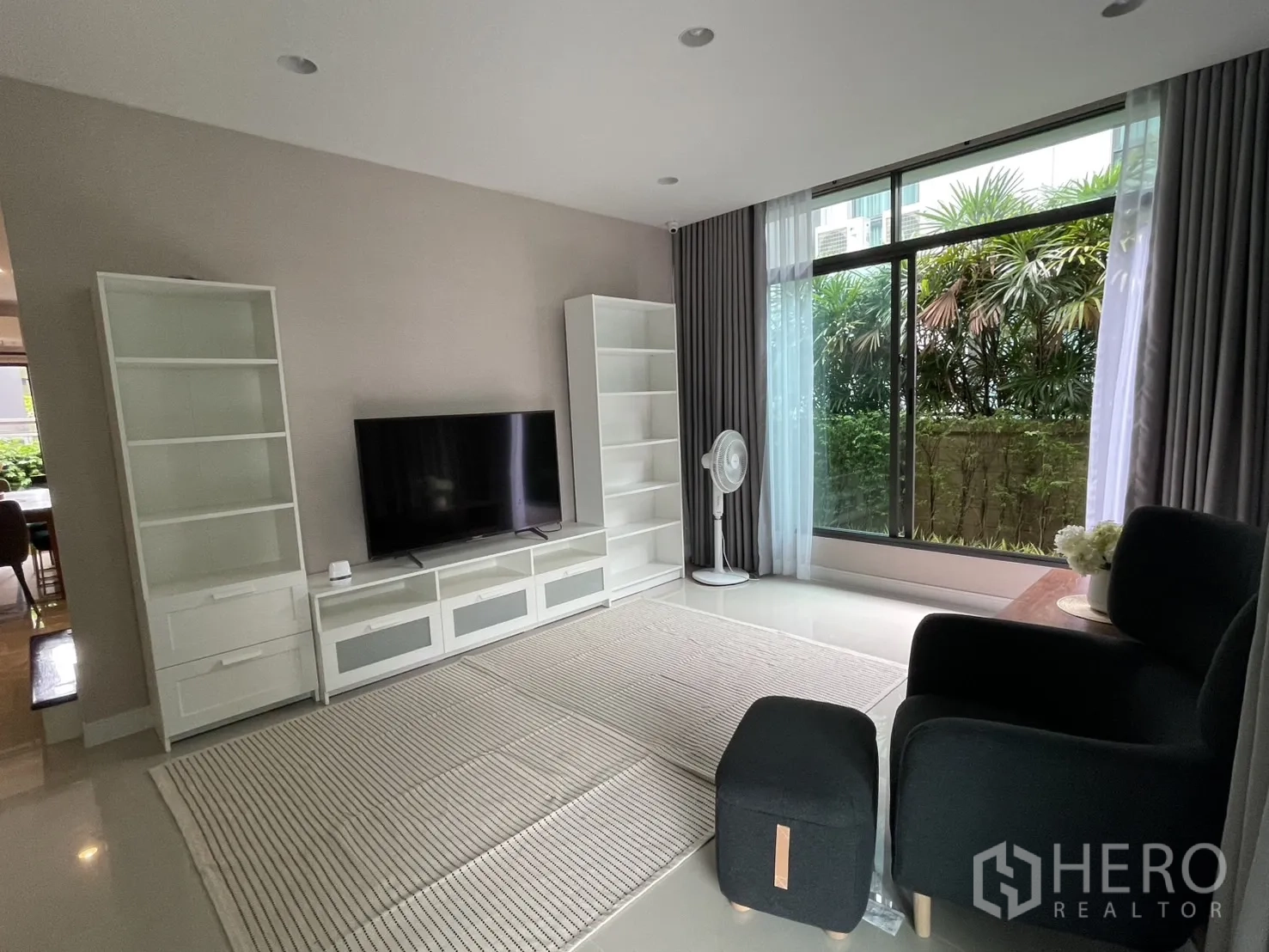 Detached House for rent in Bang Kapi, Bangkok - Living area view facing the garden through floor-to-ceiling windows.