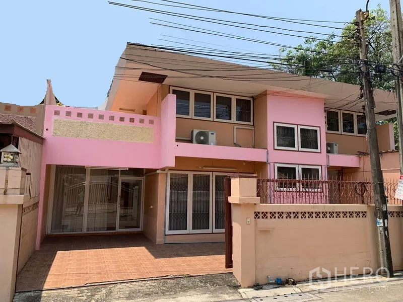 Office Space for rent in Chatuchak, Bangkok - Two-storey building exterior with pink facade, gated frontage and covered parking.