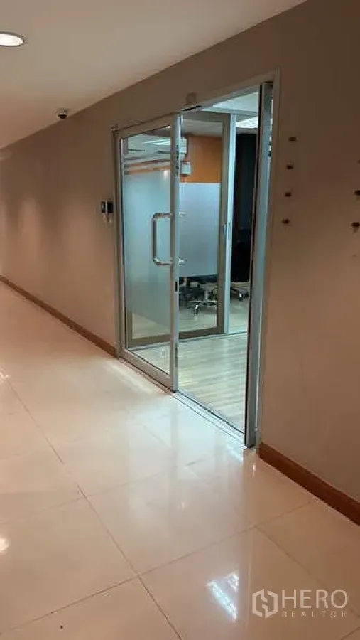 Office Space for rent - Glass entry door with frosted panel opening from the corridor into the office suite.