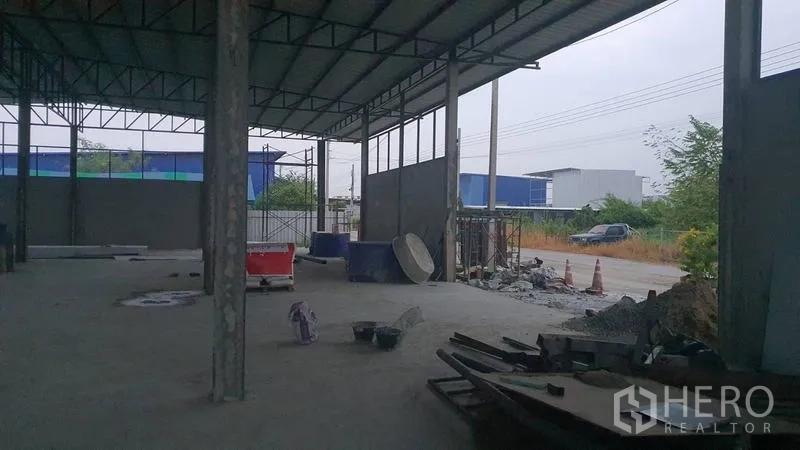 货栈 出租在Khlong Sam Wa, Bangkok - 仓库装卸区朝向道路，地面放置施工材料