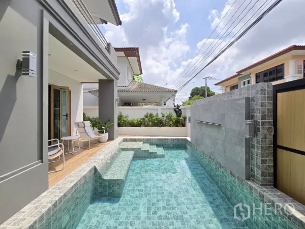 Detached House for sale in Suan Luang, Bangkok - Lap-style pool running along the deck with high privacy wall and planters.
