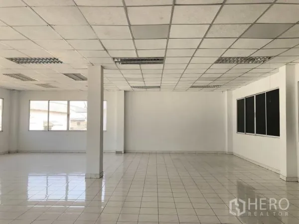 Warehouse for rent in Phra Nakhon Si Ayutthaya - Bright tiled office space with suspended ceiling and large windows inside the building.