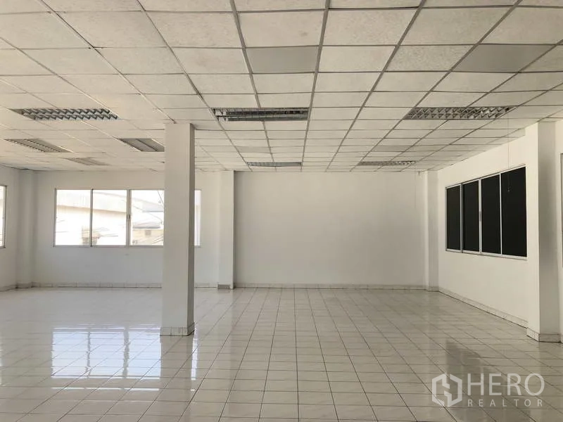 Warehouse for rent in Phra Nakhon Si Ayutthaya - Bright tiled office space with suspended ceiling and large windows inside the building.