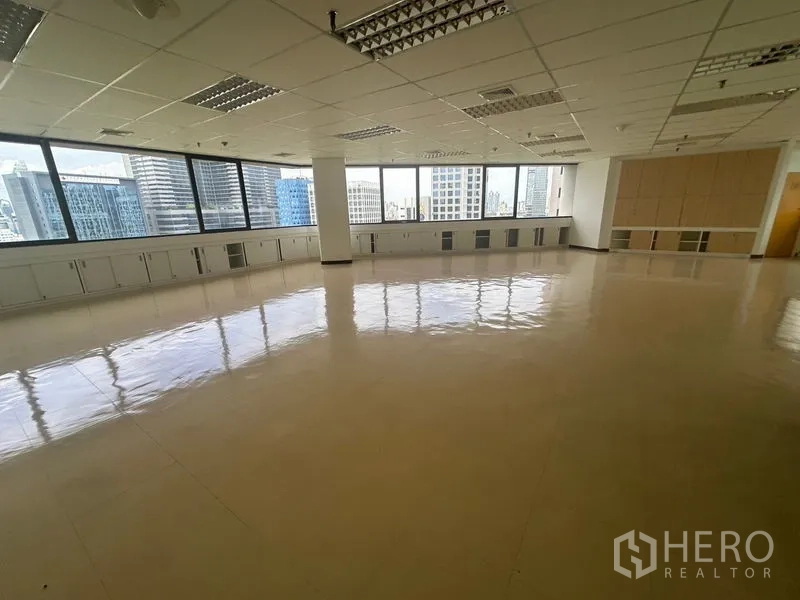 Office Space for rent in Bang Rak, Bangkok - Panoramic windows, built-in cabinets and open workspace overlooking city towers.