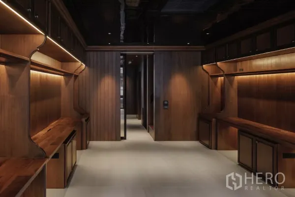 Office Space for rent in Bang Rak, Bangkok - Open plan workspace with built‑in wooden counters and warm LED strip lighting