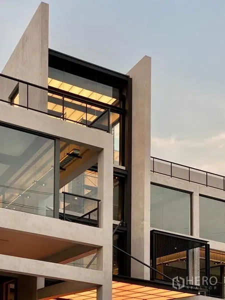 Retail Space for rent - Modern multi-level retail building exterior with dramatic glass façade and angular concrete lines in Bang Na, Bangkok.