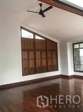 Retail Space for rent in Bangkok - Upper-level room with sloped ceiling, ceiling fan, wooden shutters and wide windows.