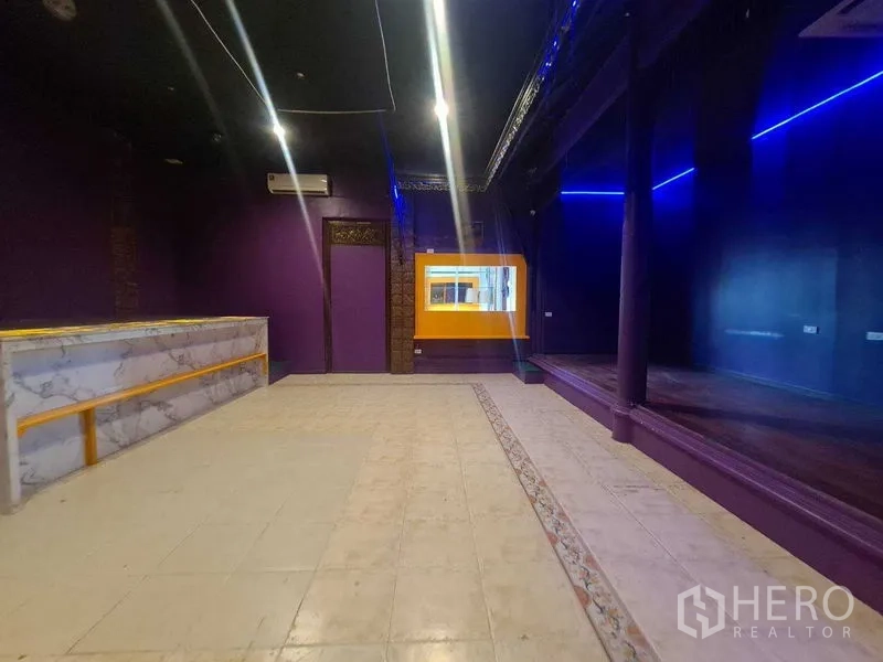 Retail Space for rent in Watthana, Bangkok - Main retail hall featuring a marble service counter, stage platform and blue LED accent lighting.