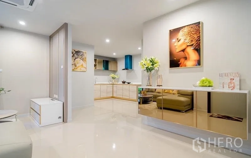Detached House for sale in Lam Luk Ka, Pathum Thani - Open living and kitchen zone with glossy cabinetry and decor.