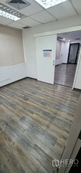 Office Space for rent in Watthana, Bangkok - Small private office with a sliding door and wood flooring.