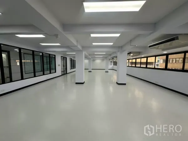 Office Space for rent - Long rectangular office zone with strip windows, air-conditioning units and glass meeting rooms.