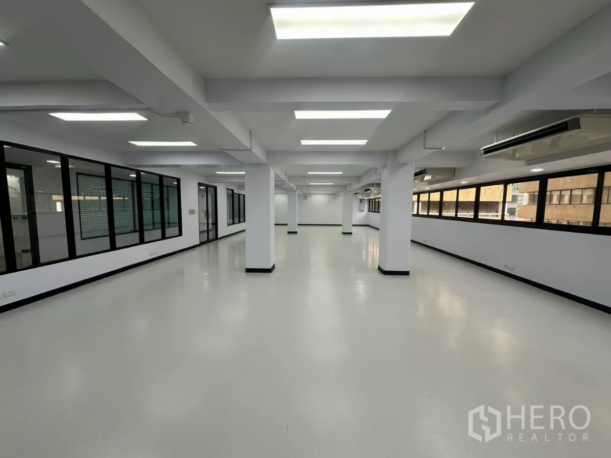 Office Space for rent - Long rectangular office zone with strip windows, air-conditioning units and glass meeting rooms.