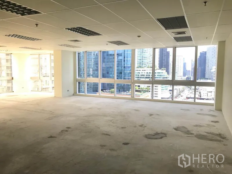 Office Space for rent in Khlong Toei, Bangkok - Large open office showing ceiling tiles, air vents, and wide windows.