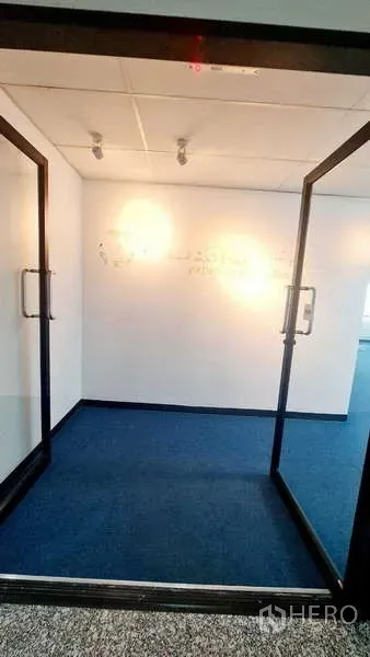 Office Space for rent in Khlong Toei, Bangkok - Entrance vestibule with twin glass doors and spotlights leading into the workspace.