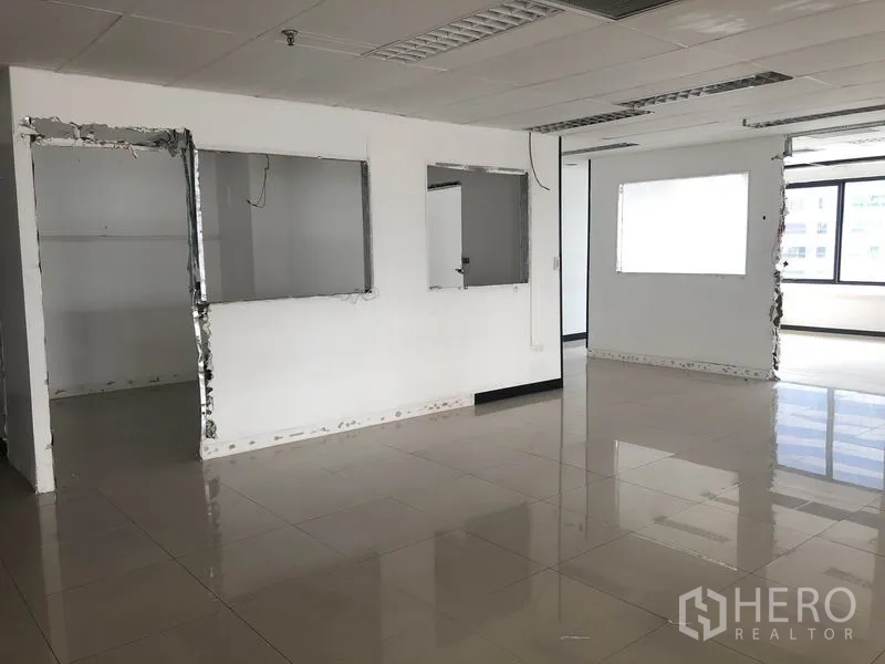 Office Space for rent in Watthana, Bangkok - Open-plan workspace with cut-out partitions and large windows.