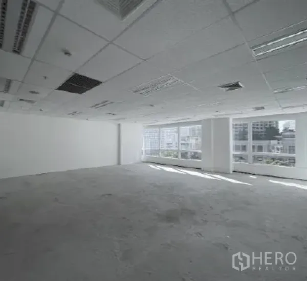 Office Space for rent - Bright open‑plan office with drop ceiling, large windows and city views.