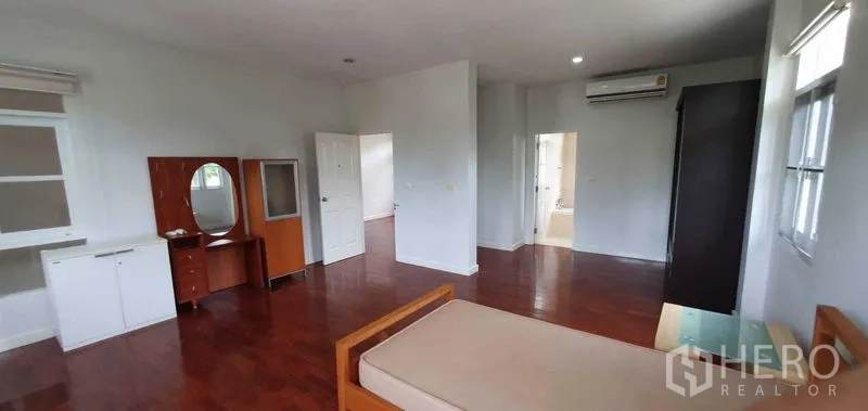 Detached House for rent in Prawet, Bangkok - Bedroom suite featuring dressing table, wardrobes and doorway to bathroom.