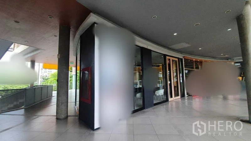 Retail Space for rent in Khlong Toei, Bangkok - Panoramic view of the curved shopfront along the mall walkway with ceiling downlights.
