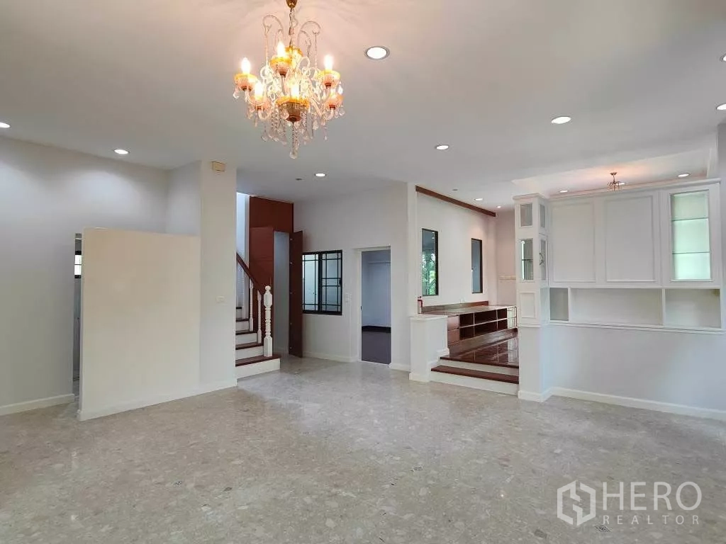 Detached House for rent or sale in Mueang Nonthaburi, Nonthaburi - Ground-floor hall showing stairs, built-in shelving and multiple living zones.