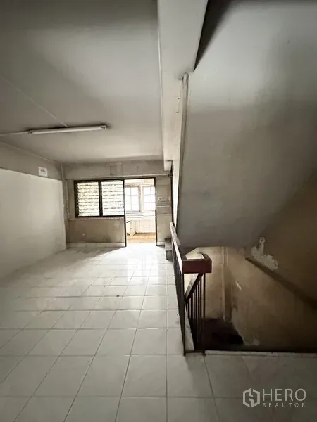 Shophouse for rent or sale in Watthana, Bangkok - Upper floor landing with windows and stair access inside the shophouse.