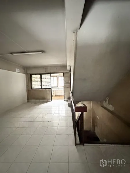Shophouse for rent or sale in Watthana, Bangkok - Upper floor landing with windows and stair access inside the shophouse.
