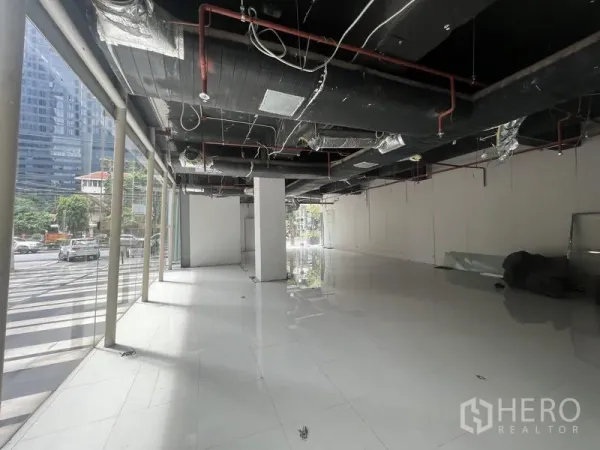 Retail Space for rent in Watthana, Bangkok - Shell retail interior with full-height windows, glossy tile floors and exposed ceiling ductwork.