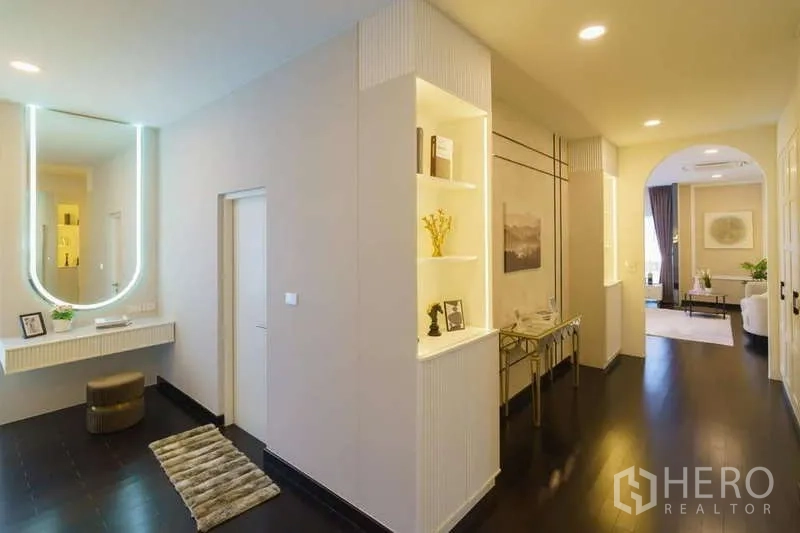 Detached House for rent or sale in Bang Phli, Samut Prakan - Upstairs hallway with vanity, built-in display shelves and soft lighting.