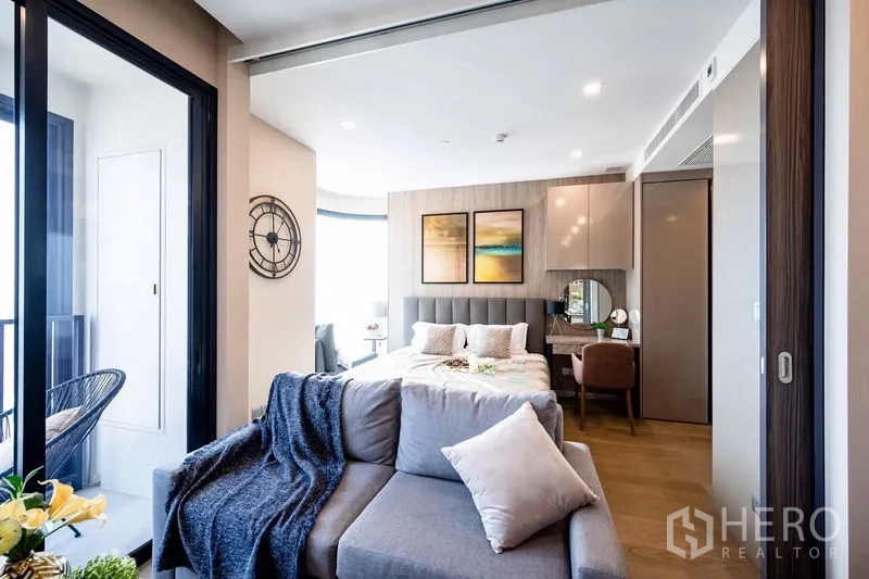 Condominium for rent in Watthana, Bangkok - Open-plan layout showing living area and bedroom separated by sliding partition.