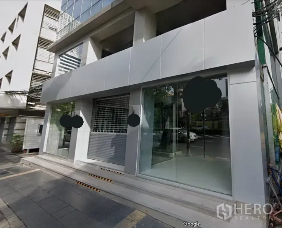 Retail Space for rent in Bang Rak, Bangkok - Modern commercial building facade in Silom with large glass storefront, roller shutter, and street access steps.