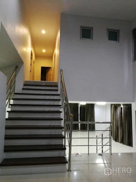 Home Office for rent in Khlong Toei, Bangkok - Staircase leading to upper hallway with recessed lighting over open area.