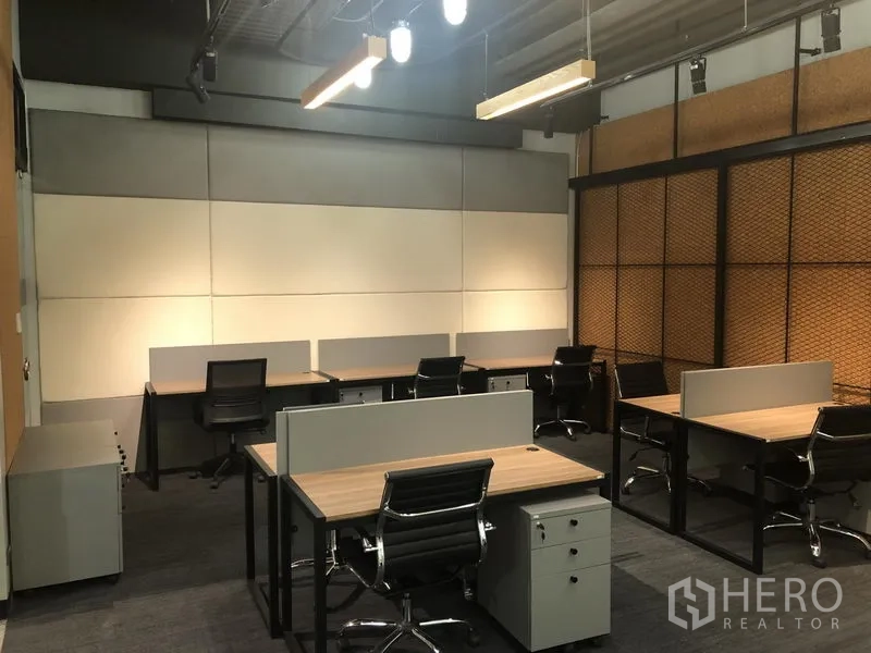 Office Space for rent in Watthana, Bangkok - Open-plan office with multiple workstations, ergonomic chairs, acoustic wall panels and pendant lighting.