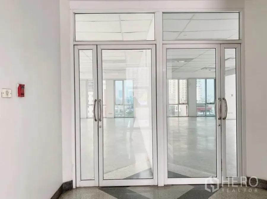 Office Space for rent in Chatuchak, Bangkok - Double glass doors leading into the office suite with city outlook beyond.
