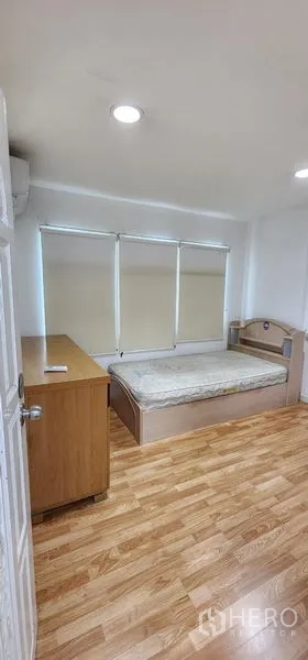 Detached House for rent in Lat Phrao, Bangkok - Expansive ground-floor hall with recessed ceiling lights and a timber staircase.