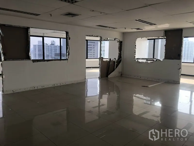 Office Space for rent in Watthana, Bangkok - Open office area with partition frames and multiple windows facing city towers.