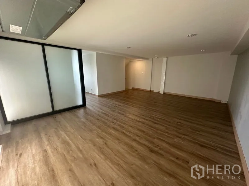 Home Office for rent in Suan Luang, Bangkok - Small glass-enclosed office with balcony railing and windows.