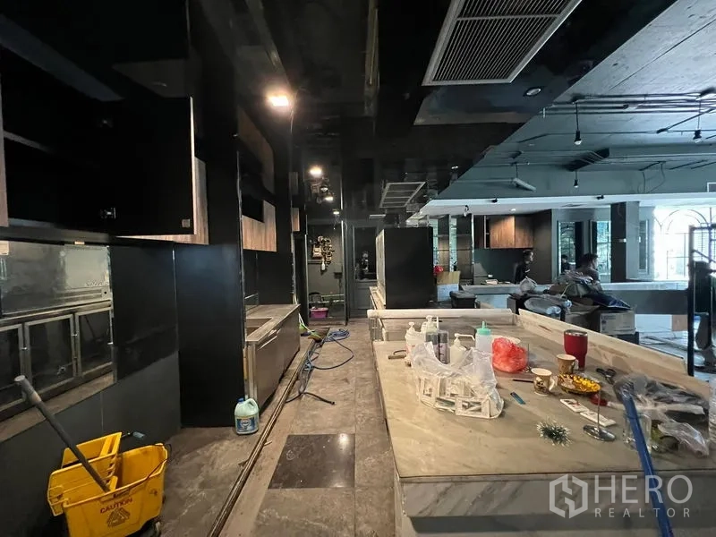 零售空间 出租 - 长吧台大理石台面，深色定制柜体，氛围现代。