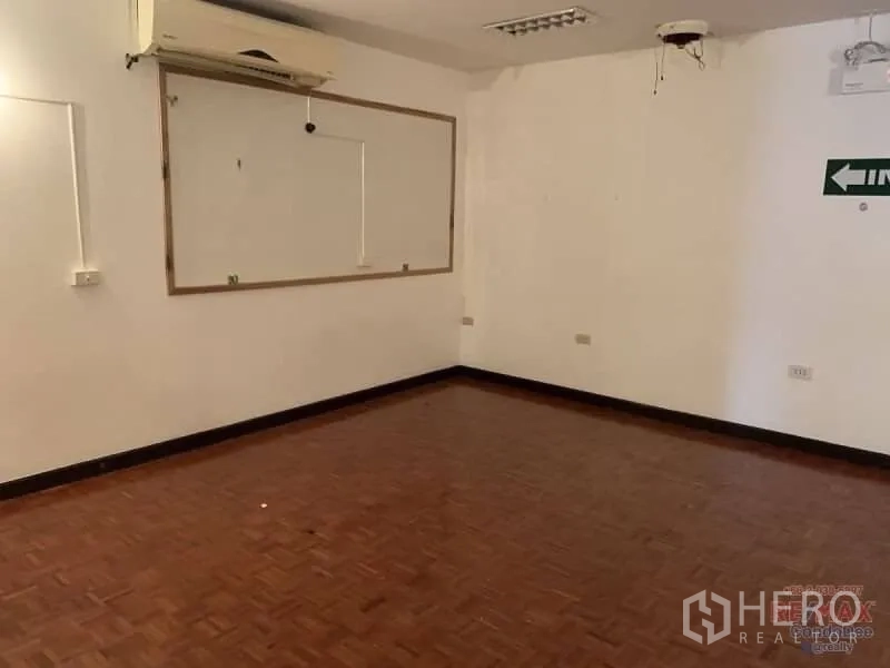 Retail Space for rent in Watthana, Bangkok - Open room with parquet floor, air-conditioning and blank walls ready for retail fit-out.